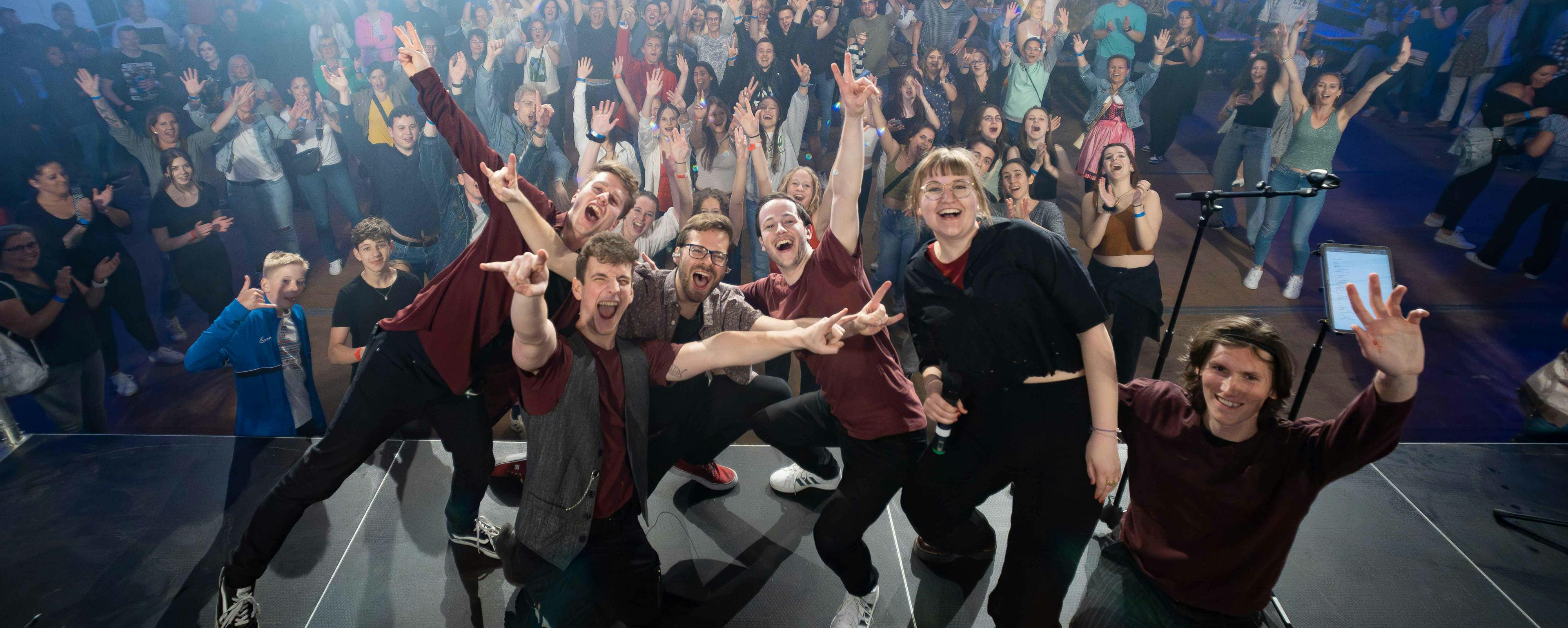 picture of the band celebrating in front of a crowd
